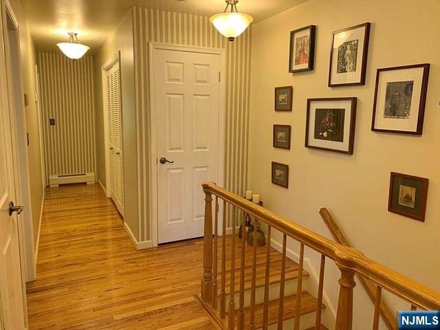 126 Hawthorne Avenue Park Ridge, NJ 07656 - Photo 15 of 22 a view of a hallway with wooden floor and staircase