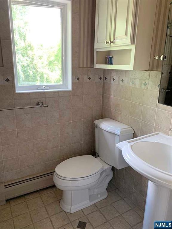 126 Hawthorne Avenue Park Ridge, NJ 07656 - Photo 20 of 22 a white toilet sitting next to a bathroom sink