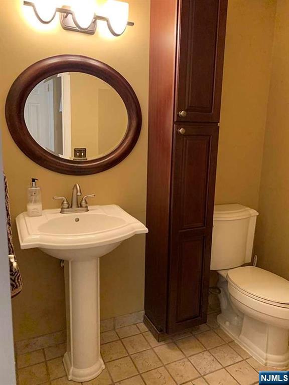 126 Hawthorne Avenue Park Ridge, NJ 07656 - Photo 21 of 22 a bathroom with a sink and a mirror
