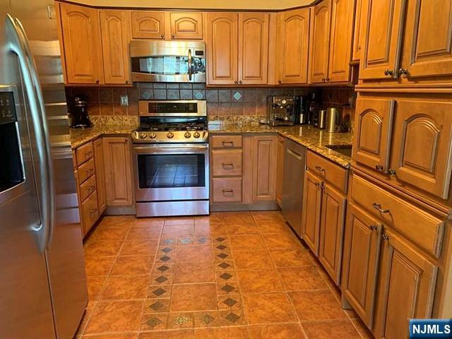 126 Hawthorne Avenue Park Ridge, NJ 07656 - Photo 6 of 22 a kitchen with stainless steel appliances granite countertop a stove a sink and a refrigerator