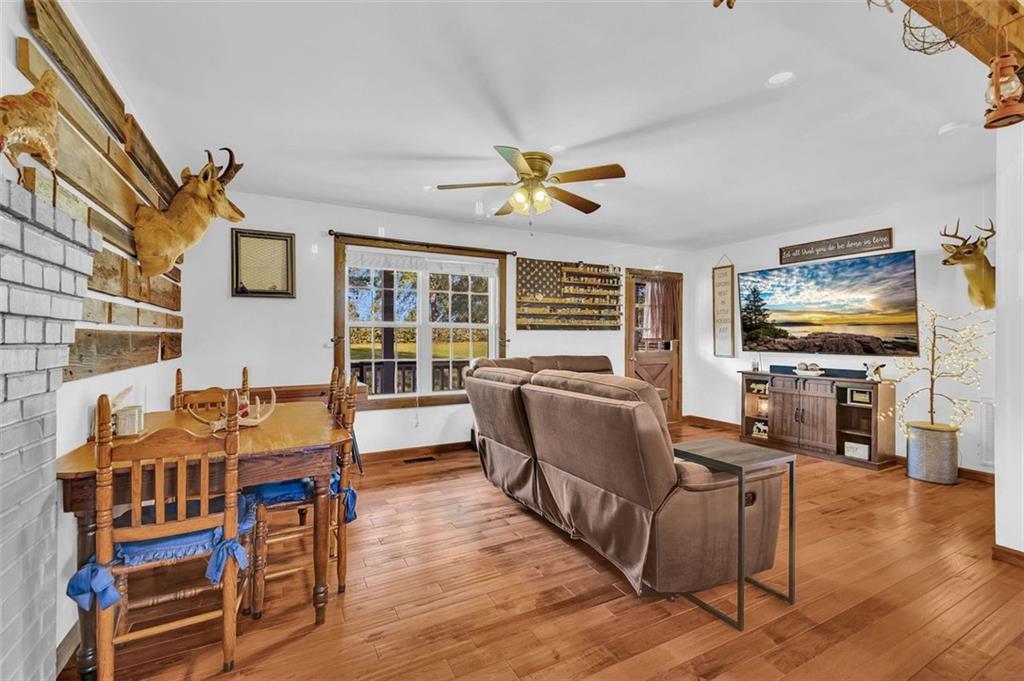 340 Tom Bell Road Milner, GA 30257 - Photo 11 of 34 a living room with fireplace furniture and a flat screen tv