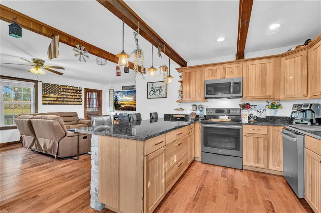 340 Tom Bell Road Milner, GA 30257 - Photo 13 of 34 a kitchen with stainless steel appliances granite countertop lots of counter top space