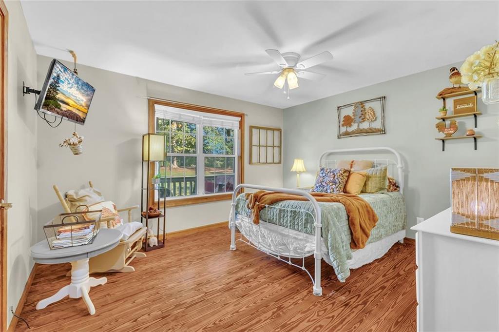 340 Tom Bell Road Milner, GA 30257 - Photo 16 of 34 a living room with a bed furniture and a window