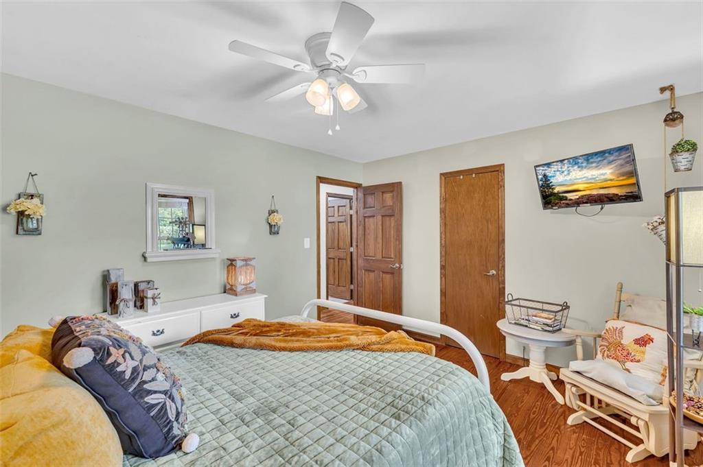 340 Tom Bell Road Milner, GA 30257 - Photo 17 of 34 a bedroom with a bed and a chandelier