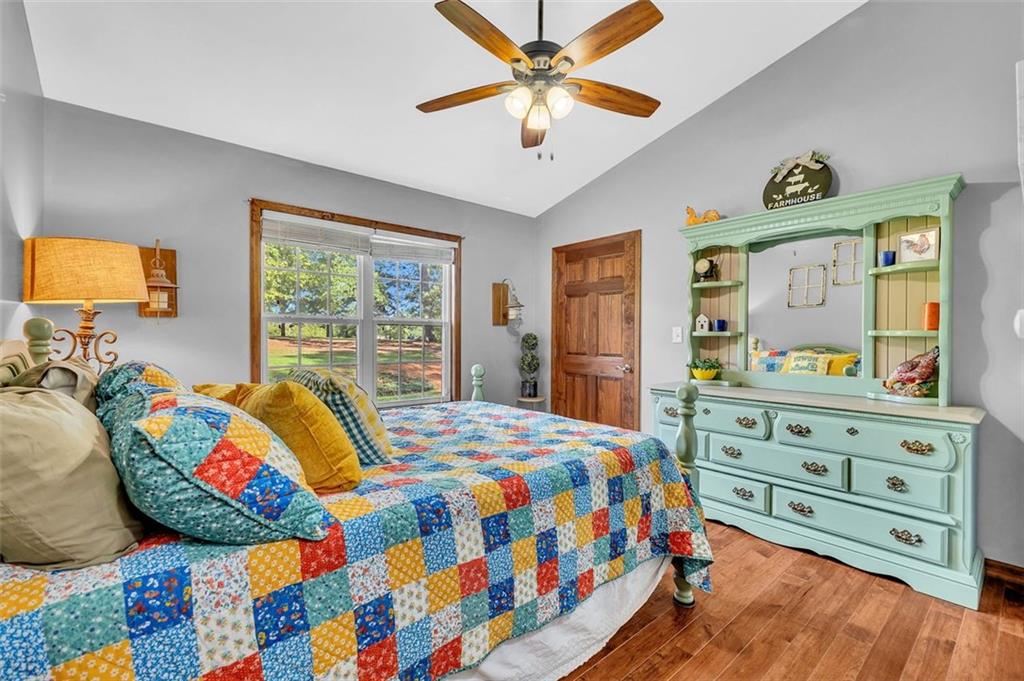 340 Tom Bell Road Milner, GA 30257 - Photo 18 of 34 a bedroom with a bed and a dresser in it