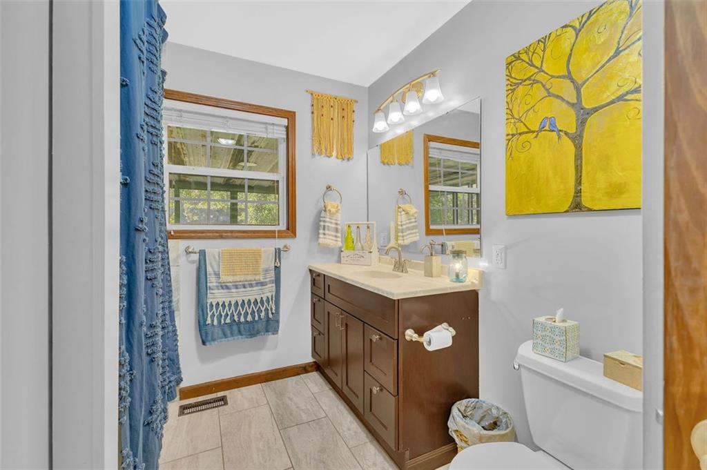 340 Tom Bell Road Milner, GA 30257 - Photo 19 of 34 a bathroom with a sink a toilet and a shower