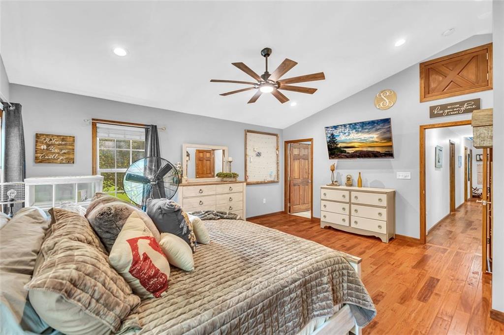 340 Tom Bell Road Milner, GA 30257 - Photo 21 of 34 a bedroom with a bed and wooden floor