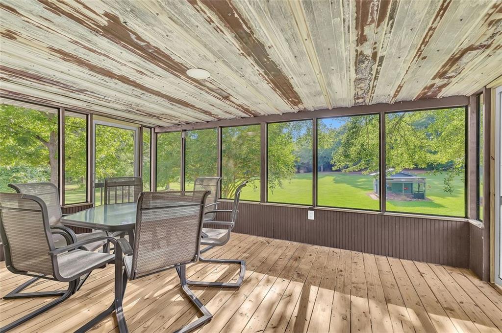 340 Tom Bell Road Milner, GA 30257 - Photo 23 of 34 a view of a patio with lawn chairs next to a yard
