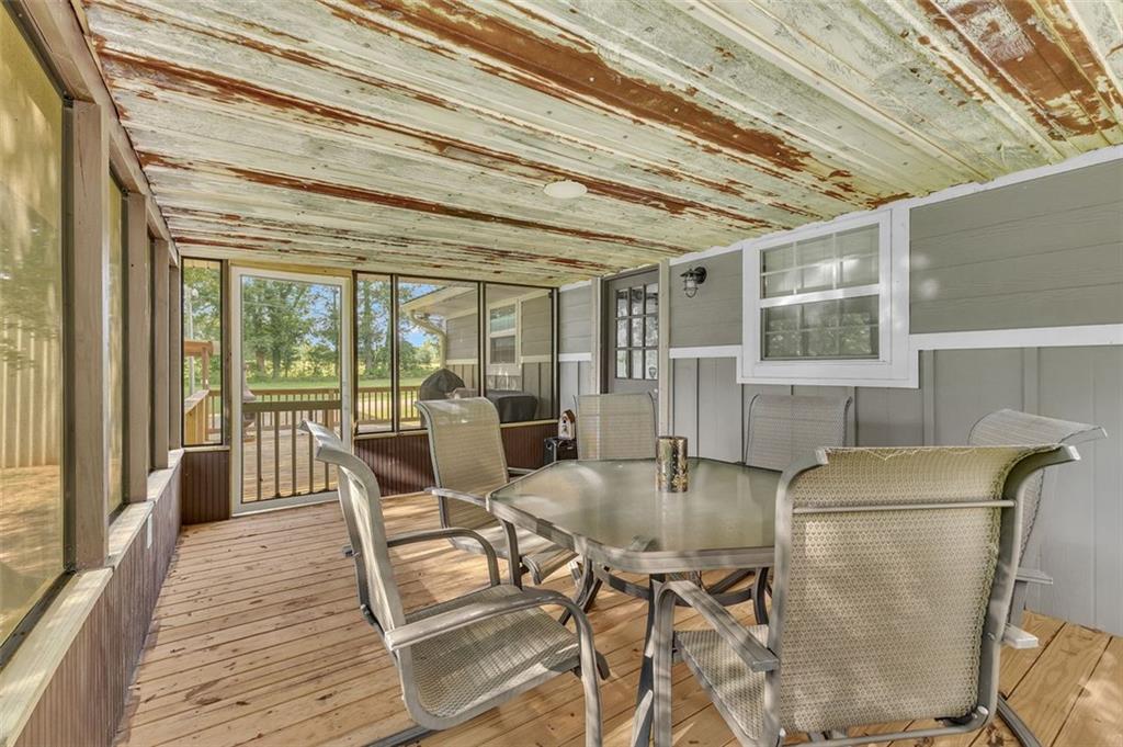 340 Tom Bell Road Milner, GA 30257 - Photo 24 of 34 a dining room with furniture and wooden floor