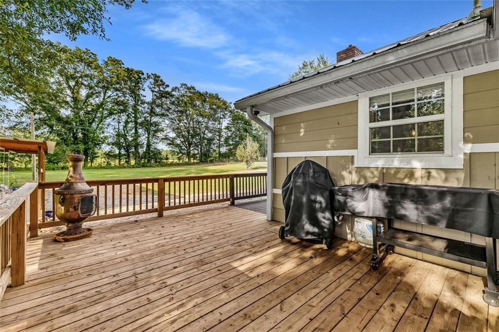 340 Tom Bell Road Milner, GA 30257 - Photo 25 of 34 a view of a chair and table on the wooden deck