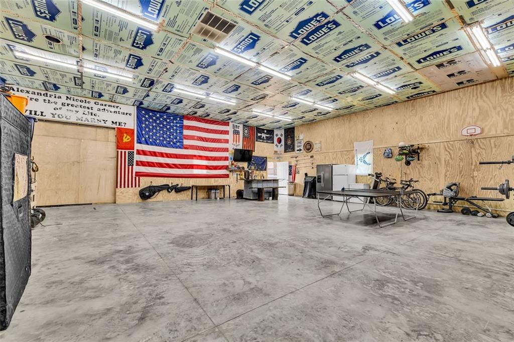 340 Tom Bell Road Milner, GA 30257 - Photo 29 of 34 a room with lots of furniture and a chandelier