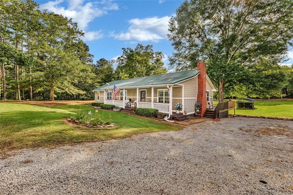 340 Tom Bell Road Milner, GA 30257 - Photo 4 of 34 a view of a house with backyard and trees