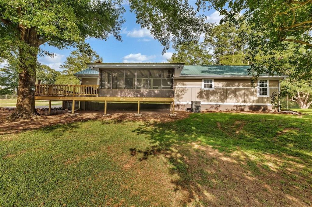 340 Tom Bell Road Milner, GA 30257 - Photo 6 of 34 a front view of a house with a yard table and chairs