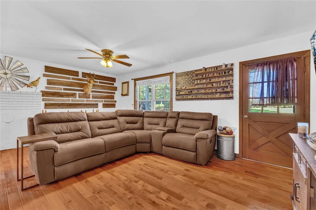 340 Tom Bell Road Milner, GA 30257 - Photo 10 of 34 a living room with furniture and a large window