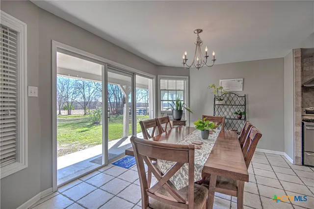 a view of a dining room with furniture large windows and wooden floor