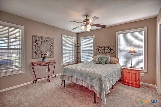 a bedroom with a bed and windows