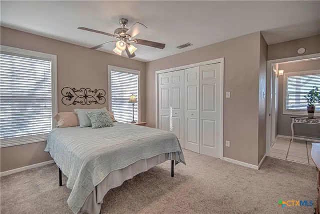 a bedroom with a large bed and a chandelier