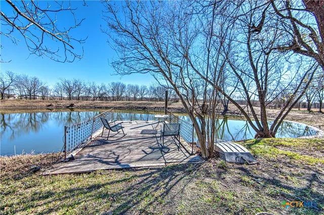 a view of a backyard with wooden floor and lake view