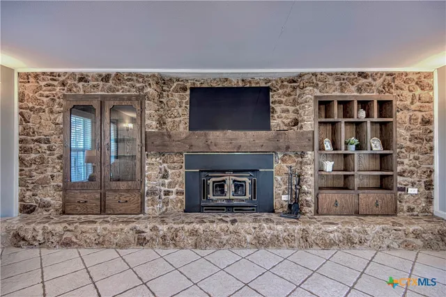 a living room with a fireplace and a rug