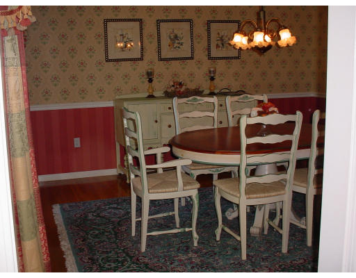 16 Windsor Road Walpole, MA 02032 - Photo 3 of 7 a dining room with furniture and a chandelier