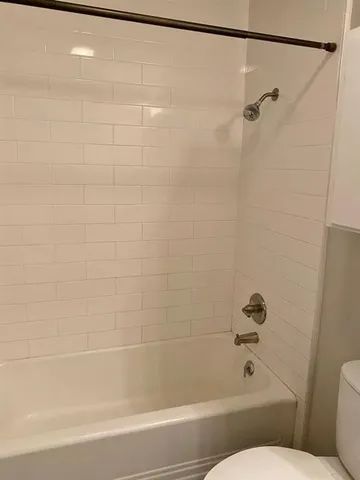 a bathroom with a shower and a toilet