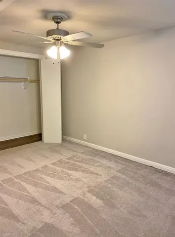 a view of a room with a ceiling fan