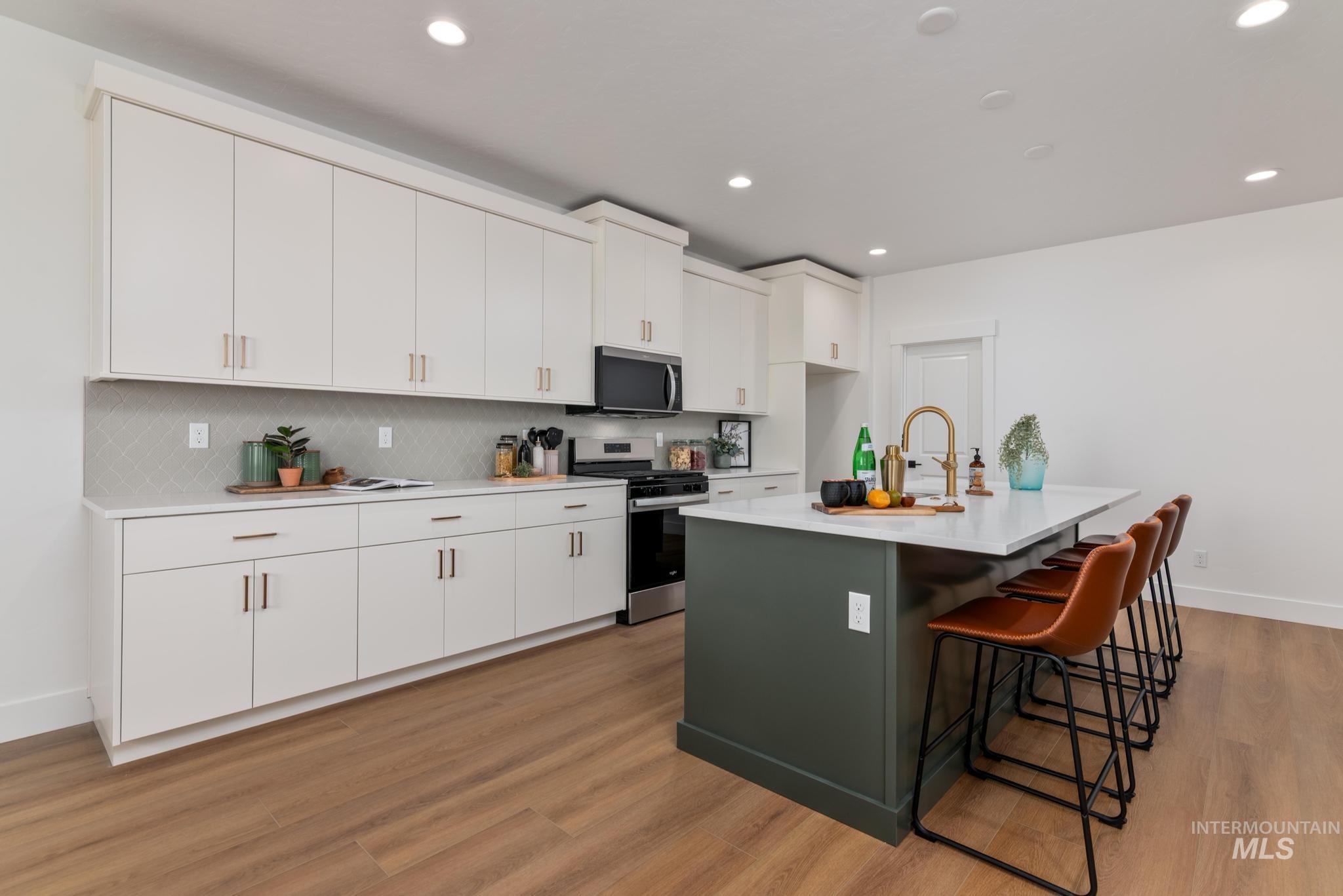 1925 Buckbrush Avenue Middleton, ID 83644 - Photo 6 of 20 Kitchen featuring light-finish cabinetry, stainless steel appliances, and wood-finish flooring