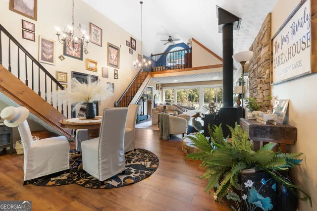 a dining room with furniture potted plants and wooden floor