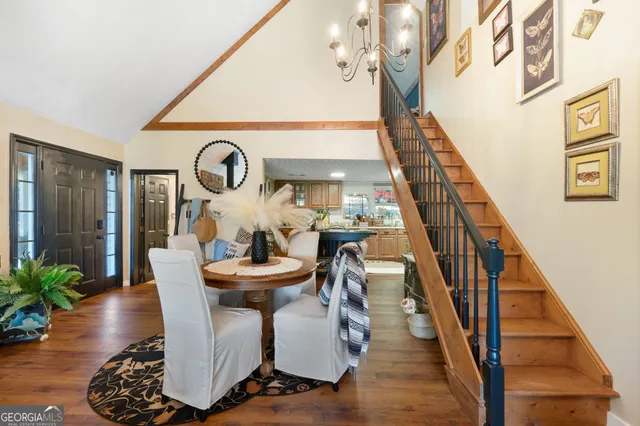 a kitchen with a table chairs refrigerator and cabinets