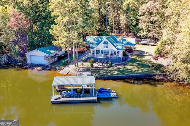 a view of house with swimming pool yard and outdoor seating