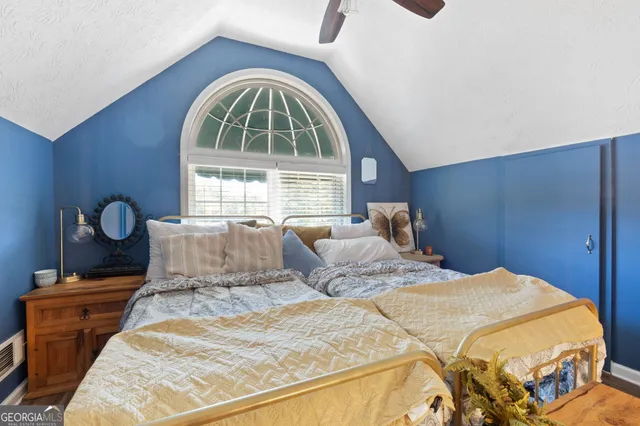 a bedroom with a bed and a window