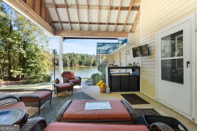 a view of balcony with wooden floor and seating space