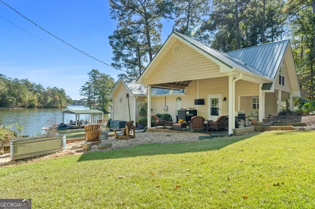 an aerial view of a house with outdoor space lake view and boat
