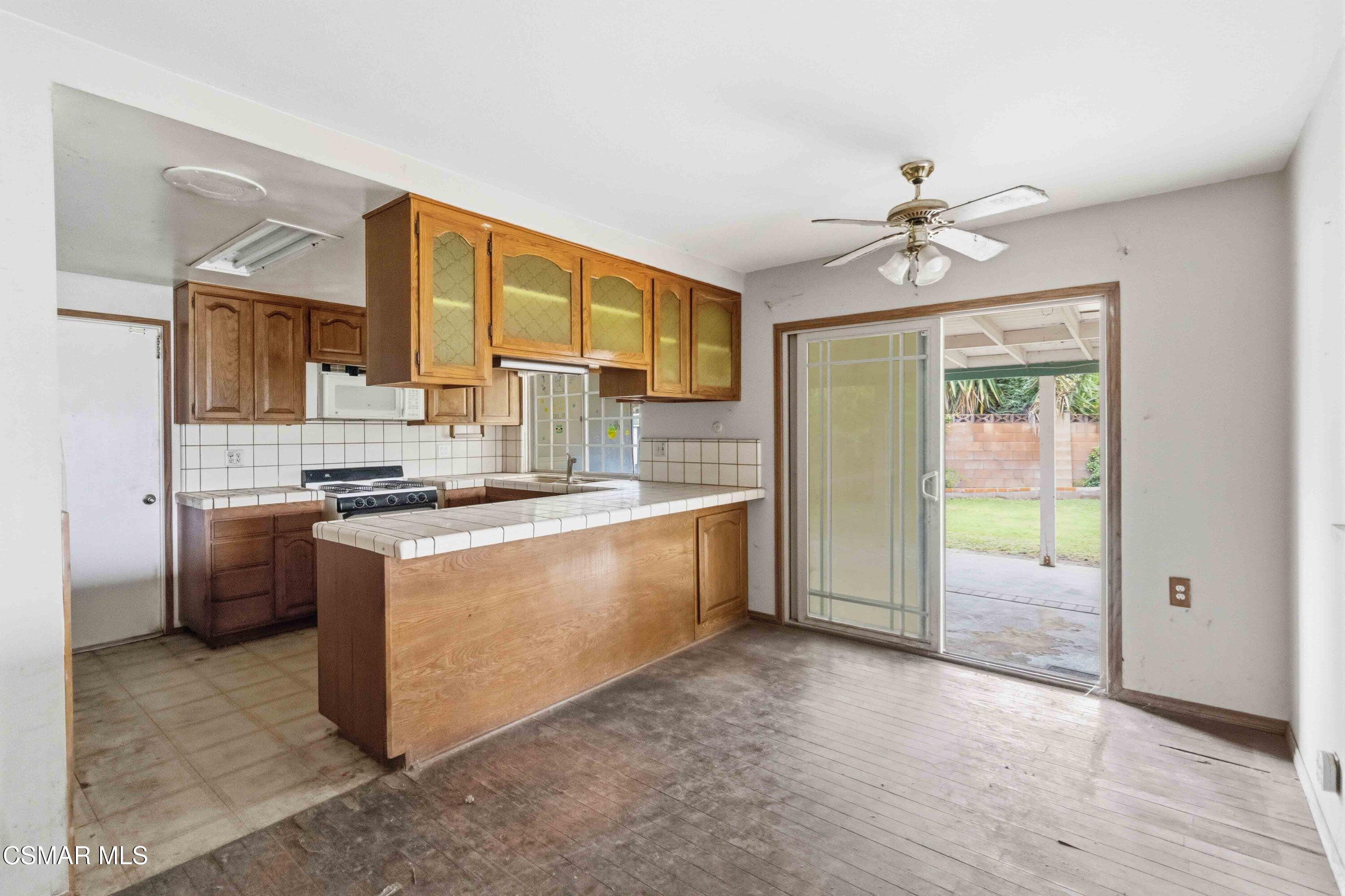 2077 Sebring Court Simi Valley, CA 93065 - Photo 6 of 20 a large kitchen with stainless steel appliances granite countertop a stove a sink dishwasher and a refrigerator