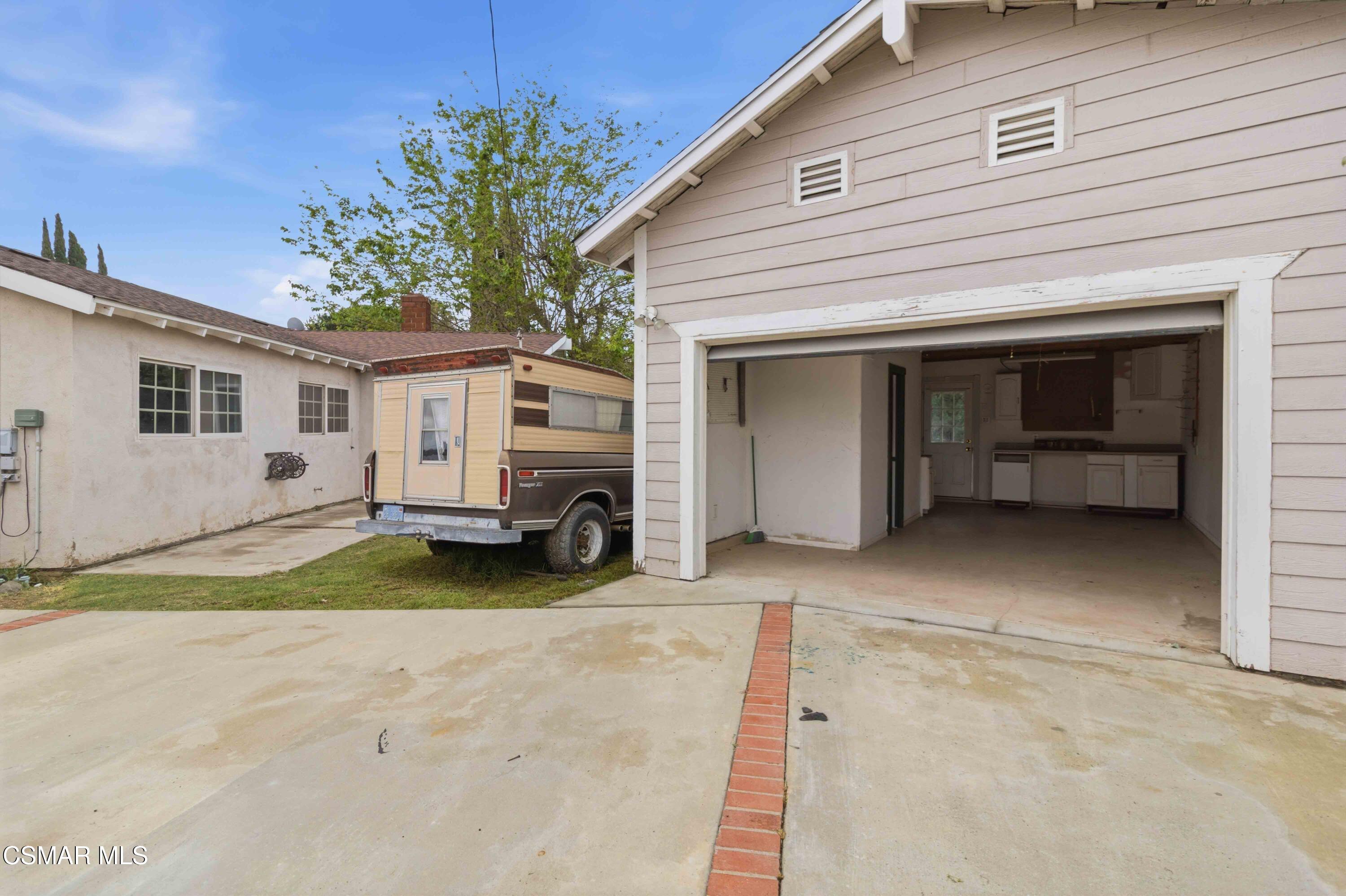 2077 Sebring Court Simi Valley, CA 93065 - Photo 10 of 20 a view of a house with a yard and garage