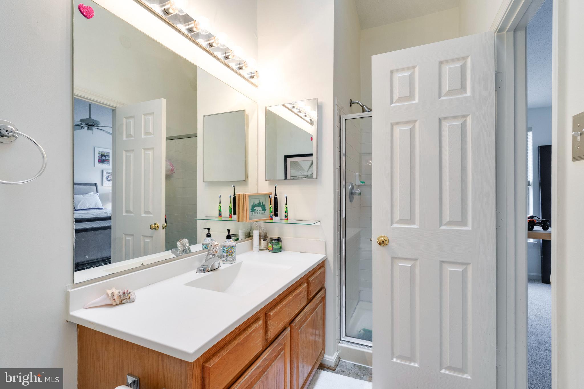 2303 Massanutten Drive Silver Spring, MD 20906 - Photo 14 of 24 a bathroom with a sink vanity and a mirror