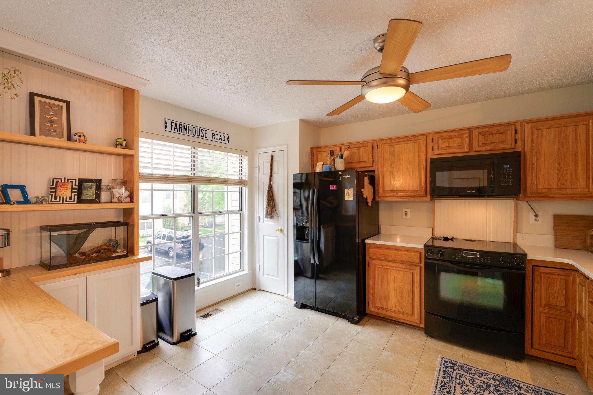 2303 Massanutten Drive Silver Spring, MD 20906 - Photo 2 of 24 a kitchen with stainless steel appliances kitchen island granite countertop a refrigerator and a stove top oven