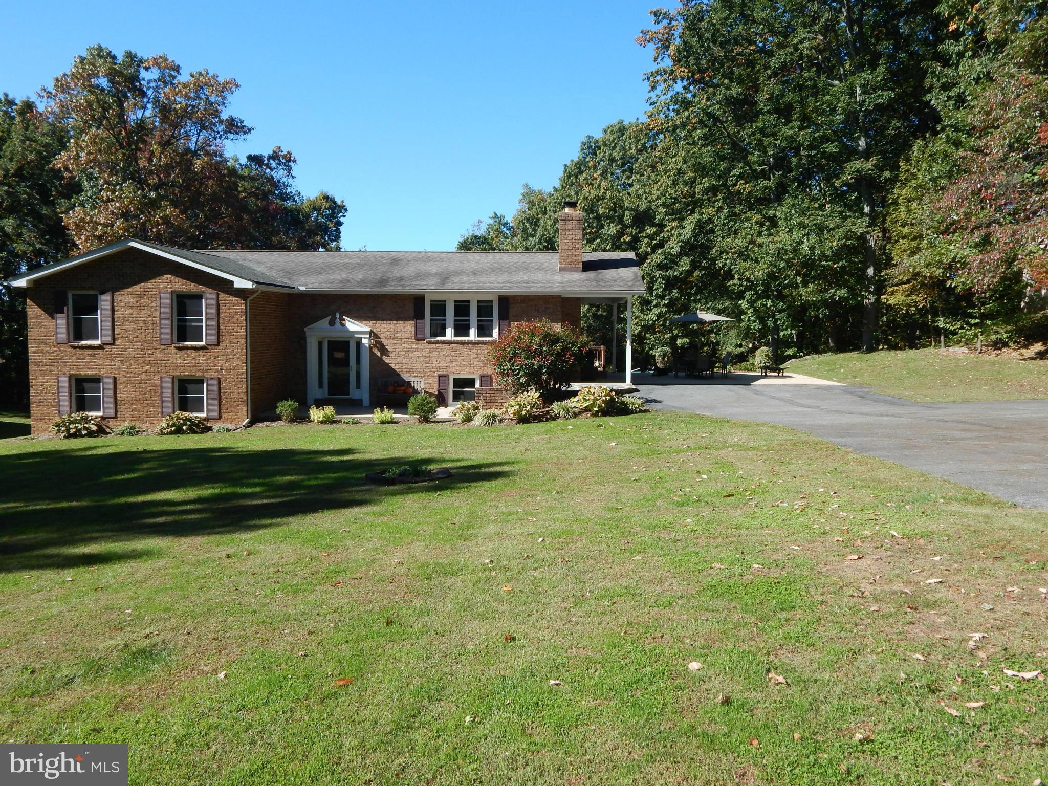 11812 Warner Road Keymar, MD 21757 - Photo 1 of 25 a view of a house with a big yard and large trees