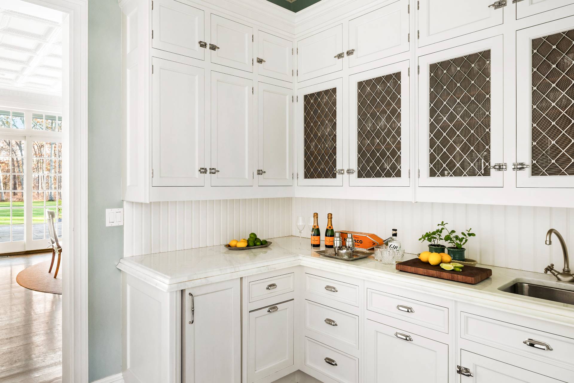 58 Wainscott Stone Road Wainscott, NY 11975 - Photo 12 of 48 a kitchen with stainless steel appliances white cabinets and a sink