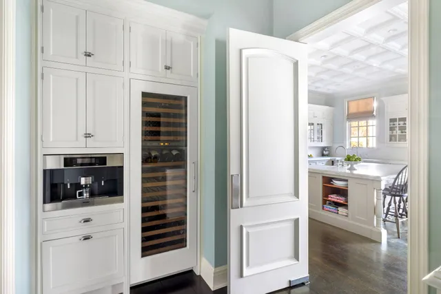 a kitchen with white cabinets and white appliances