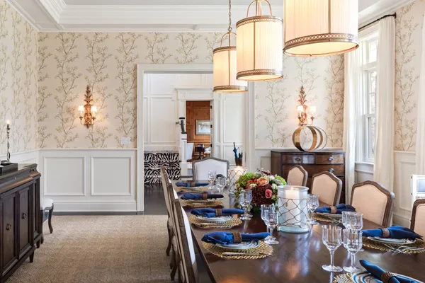 a view of a dining room with furniture and chandelier