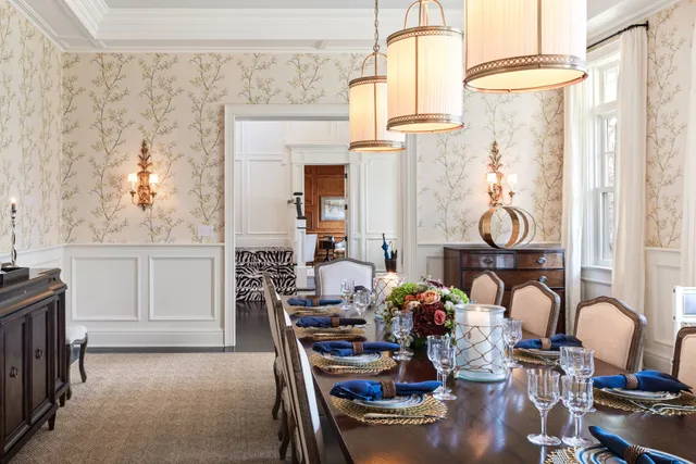 a view of a dining room with furniture and chandelier