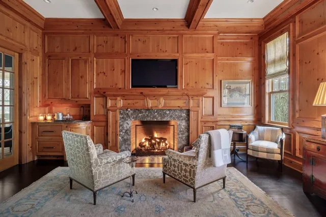a living room with furniture fireplace and flat screen tv