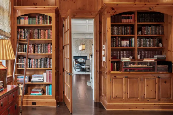 a view of a living room that has a book shelf