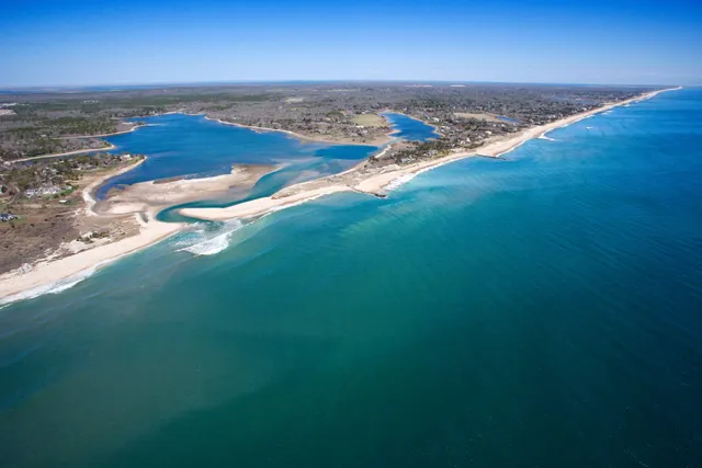 an aerial view of ocean with beach