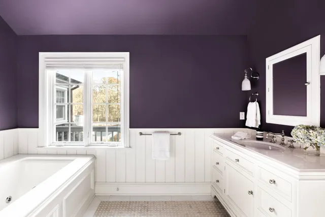 a bathroom with a bathtub sink and mirror