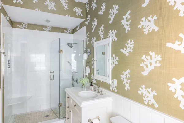 a bathroom with a sink mirror and a shower