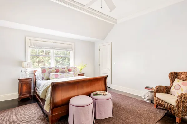 a bed room with a bed and a chair
