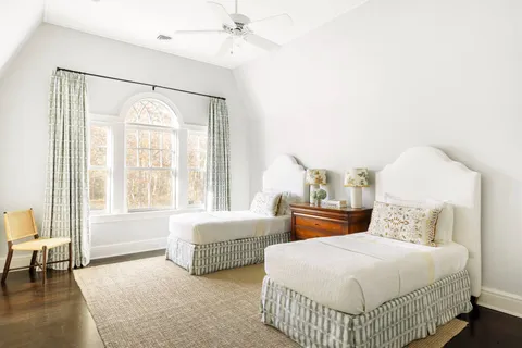 a bedroom with a bed and a mirror