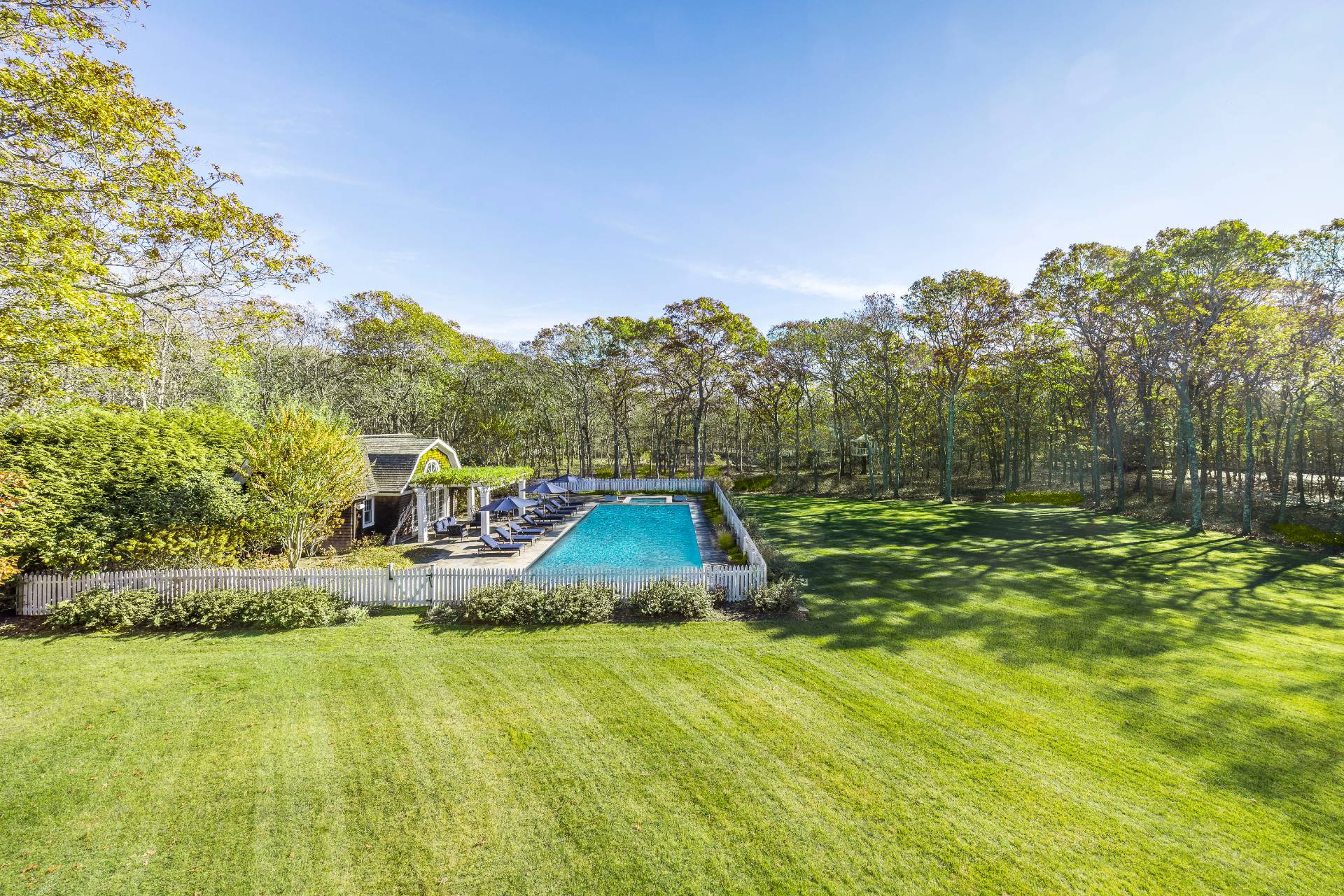 58 Wainscott Stone Road Wainscott, NY 11975 - Photo 44 of 48 a view of a swimming pool with an outdoor space and seating area